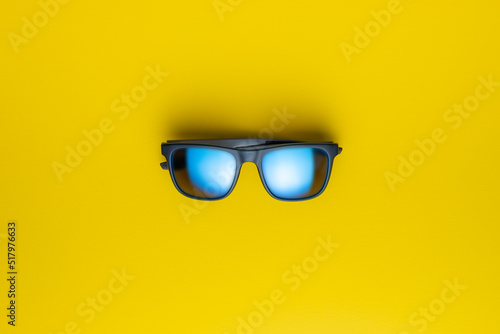 Fashion sunglasses on yellow background.