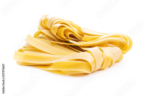Uncooked pappardelle pasta isolated on white background. photo