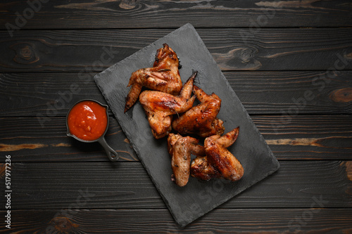 appetizing chicken wings grilled barbecue with spices and vegetables until crisp