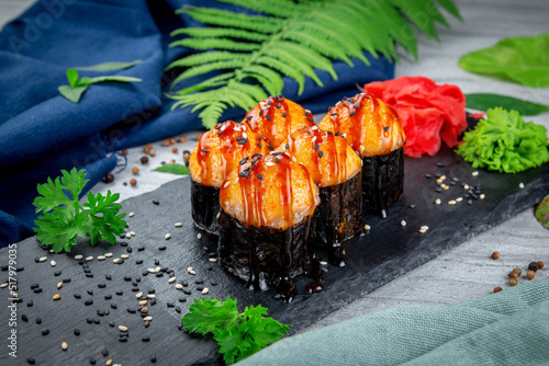 Baked sushi rolls with ayashi cap of crab sauce and unagi sauce. Traditional Japanese Cuisine
