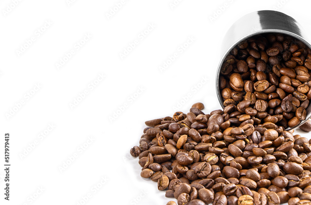 Fototapeta premium Roasted coffee beans in metal cup isolated on a white background.Copy space