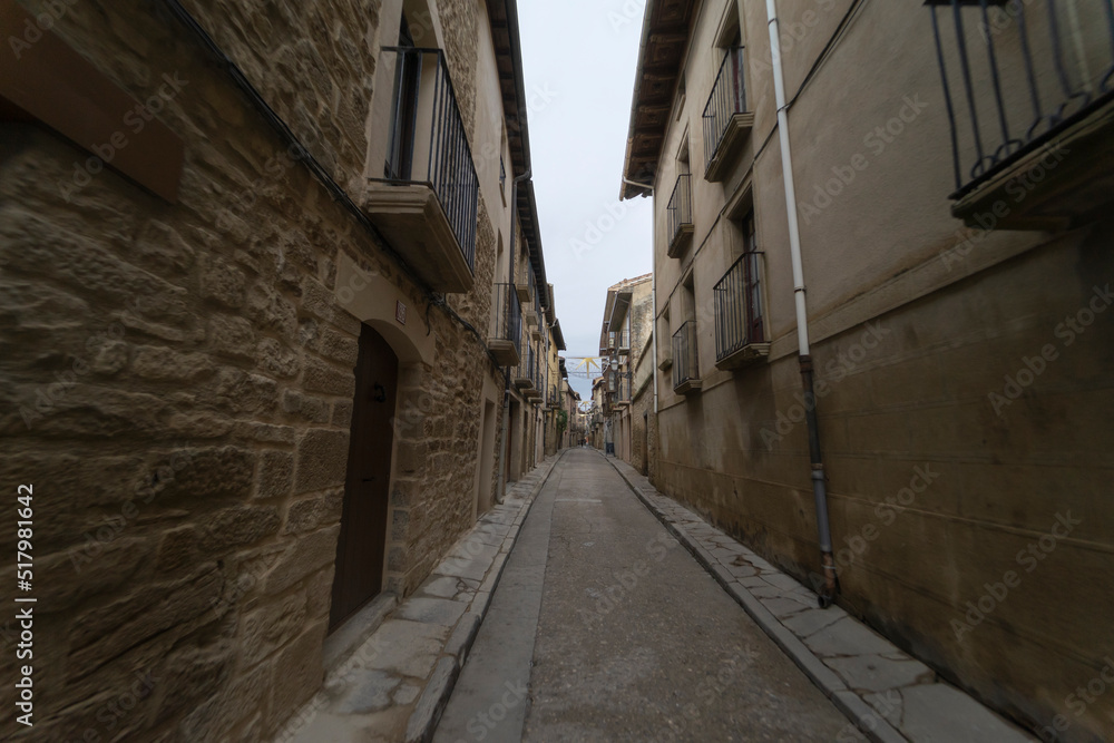 Stone streets and stone houses in the town of Olite (Spain) on a cloudy autumn day.