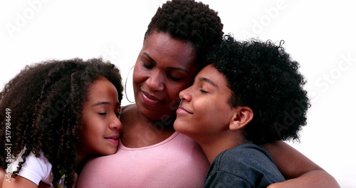 Loving mother and kids hug. Mom embracing children. African ethnicity