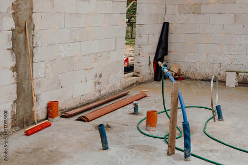 Wood modern and classic tools on newly building house construction with new roof structure , water pipes and scaffolding around building