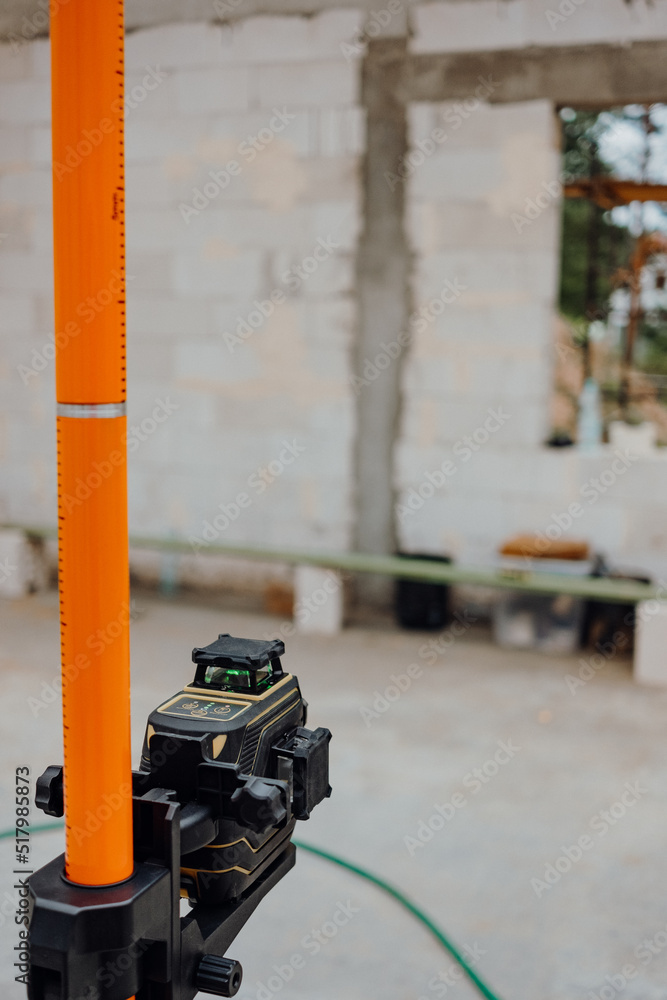 Wood modern and classic tools on newly building house construction with new roof structure , water pipes and scaffolding around building Wood modern and classic tools on newly building house construction with new roof structure , water pipes and scaffolding around building