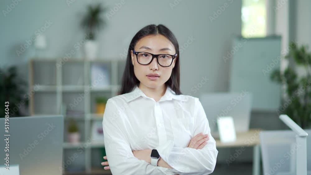 portrait of asian business lady in formal clothes and glasses looking at camera. confident proud young woman businesswoman employee entrepreneur at workplace in modern office with crossed arms. Indoor portrait of asian business lady in formal clothes and glasses looking at camera. confident proud young woman businesswoman employee entrepreneur at workplace in modern office with crossed arms. Indoor