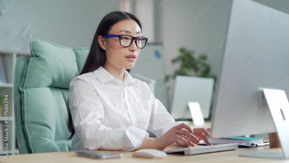 young asian business woman worker employee entrepreneur working on computer laptop sitting at desk at workplace in office. Busy attractive businesswoman in formal shirt wearing glasses using PC. Asia young asian business woman worker employee entrepreneur working on computer laptop sitting at desk at workplace in office. Busy attractive businesswoman in formal shirt wearing glasses using PC. Asia