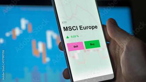 An investor's analizing the msci europe etf fund on a screen. A phone shows the prices of MSCI Europe photo