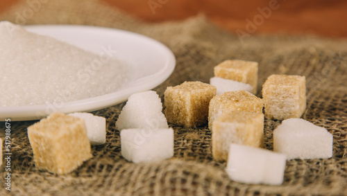 Different sugar on dark table. Sugar is unhealthy nutrition and leads to obesity, diabetes