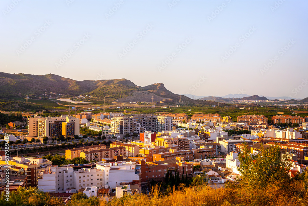 scenic landscape of a small town with mountains on a background