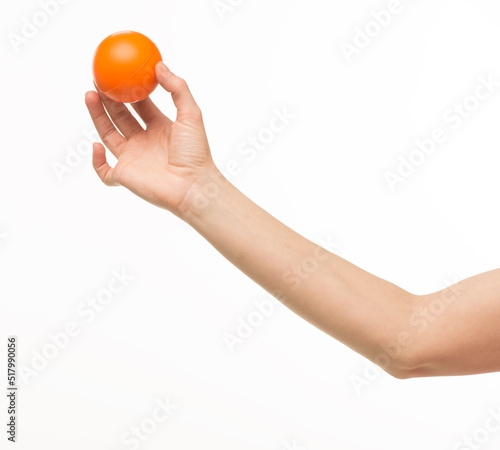 hand holding orange sponge ball isolated