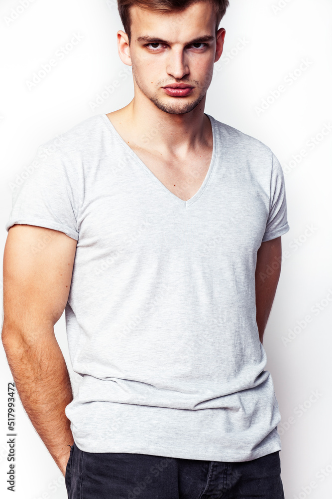 Obraz premium young handsome teenage hipster guy posing emotional, happy smiling against white background isolated, lifestyle people concept