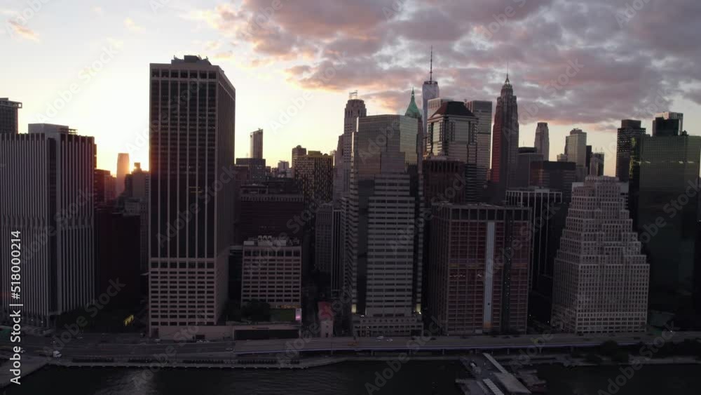 Sunset sun glimpsing through skyscrapers, in New York, USA - tracking Aerial view Sunset sun glimpsing through skyscrapers, in New York, USA - tracking Aerial view