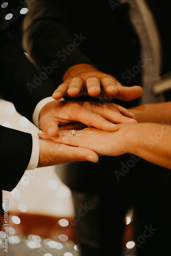 hands of bride and groom and minister