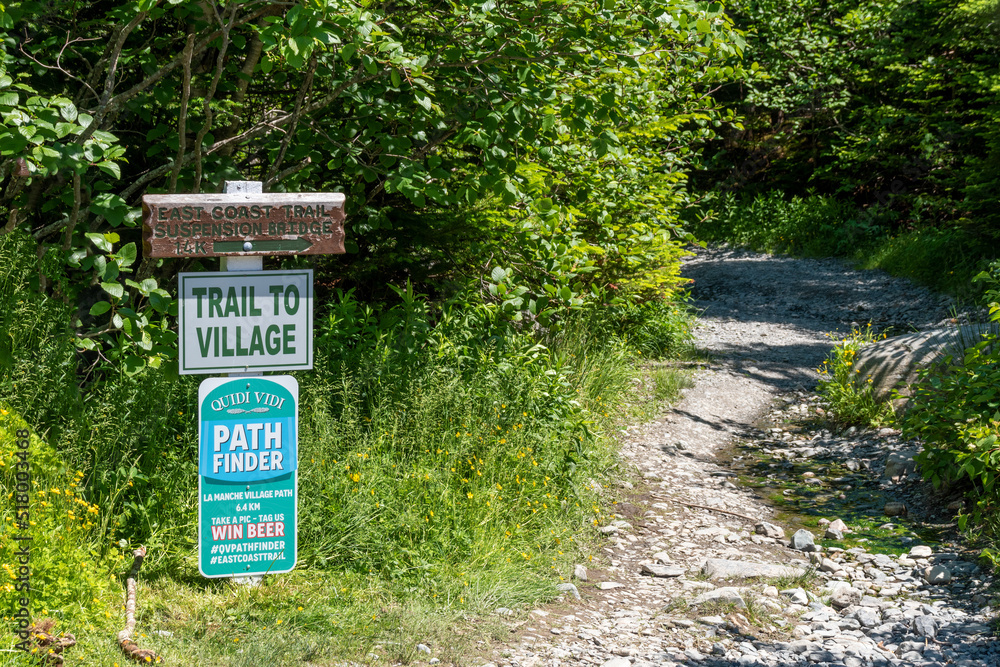 A sign marking the trailhead to the ghost town of La Manche, Newfoundland is seen at the entrance to a forest. A sign marking the trailhead to the ghost town of La Manche, Newfoundland is seen at the entrance to a forest.