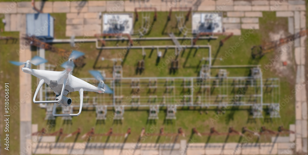 Naklejka premium Electrician use industry drone inspections electric power station electricity high voltage transmission tower, top view