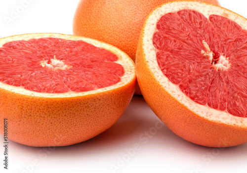 whole and cut fresh grapefruit and slices isolated on white background, Blood oranges whole and sliced on white surface. Ripe half of pink grapefruit citrus fruit, front view copy space isolated macro