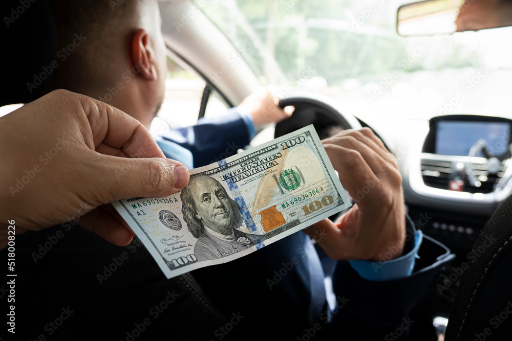 Passengers pay service fees to male taxi drivers. client pays for trip in dollars. 100 dollar