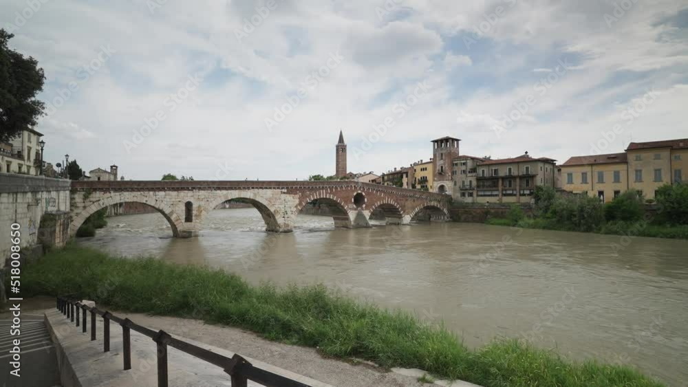 Traditional buildings on the banks of the Adige River, Ponte Pietra, Pietra stone Roman arch bridge crossing River Adige, Verona, Veneto, Italy Traditional buildings on the banks of the Adige River, Ponte Pietra, Pietra stone Roman arch bridge crossing River Adige, Verona, Veneto, Italy