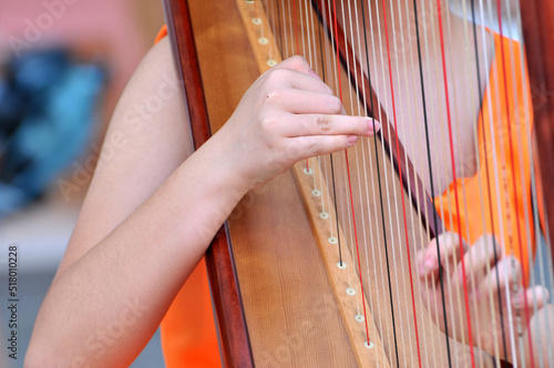 a chinese girl playing the harp 