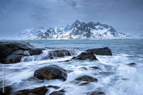 Winter landscape of sea shore and mountains in background