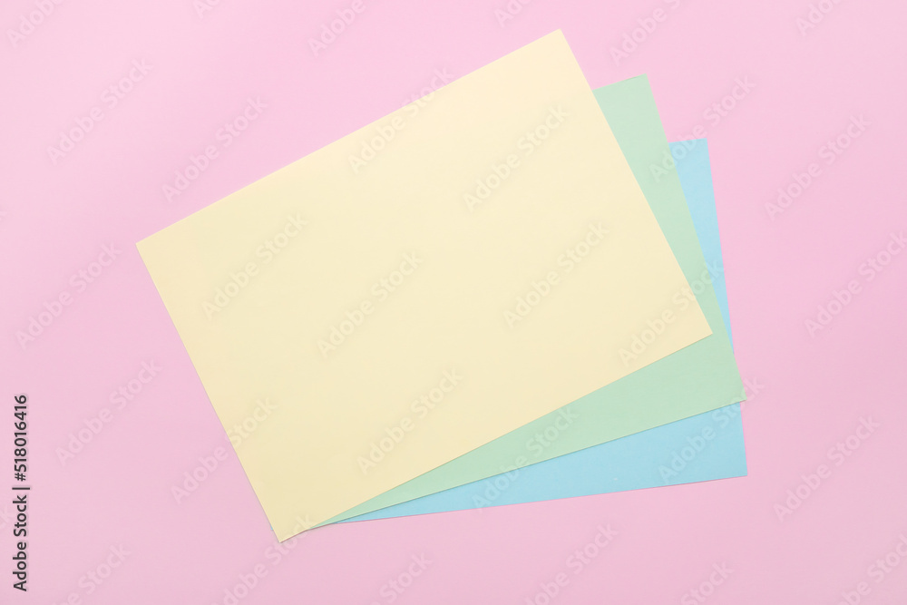 on a pink background, empty multi-colored sheets to fill on a pink background, empty multi-colored sheets to fill