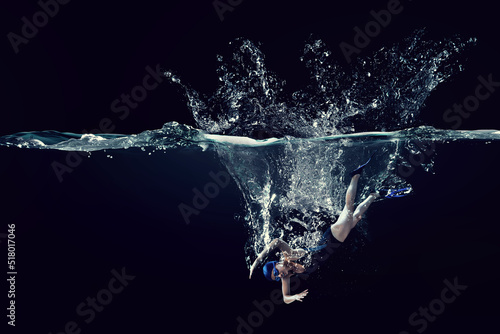 Professional woman swimmer on a wave