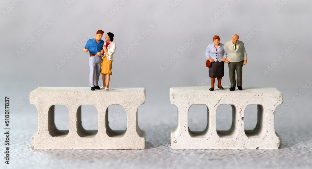 Fototapeta premium Brick and miniature people. The concept of generational conflict. 