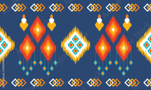 Ikat ethnic background vector. Seamless pattern in white, orange,red, blue square shapes with colorful tassels on dark blue background. Design for background, wallpaper, clothing, fabric, wrapping.