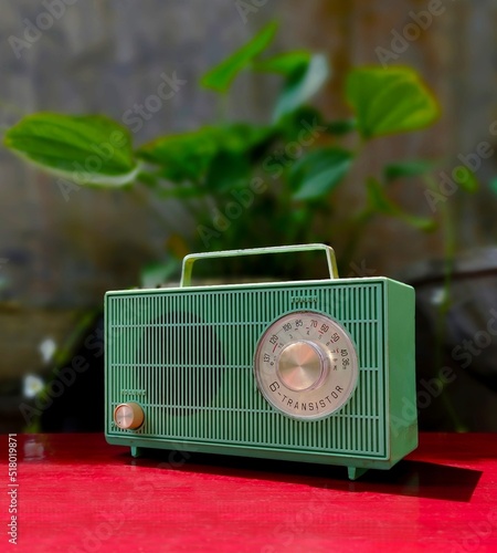 vintage 60's green transistor radio on red table