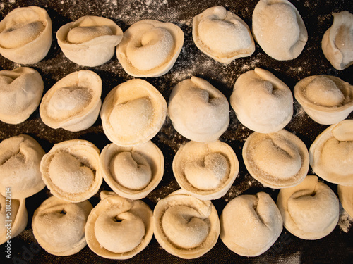 dumplings or ravioli on a tray, homemade food, raw, dough, kitchen