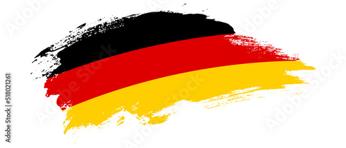 National flag of Germany with curve stain brush stroke effect on white background photo