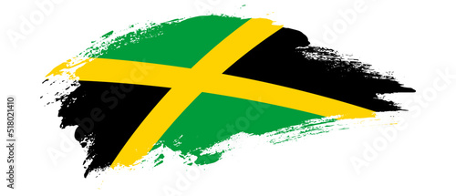 National flag of Jamaica with curve stain brush stroke effect on white background