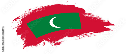 National flag of Maldives with curve stain brush stroke effect on white background photo