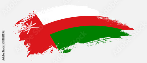 National flag of Oman with curve stain brush stroke effect on white background