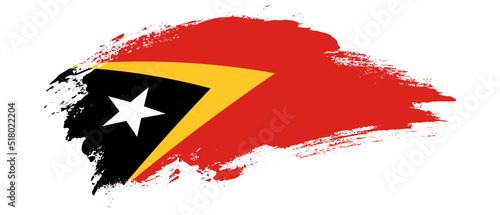 National flag of Timor Leste with curve stain brush stroke effect on white background photo