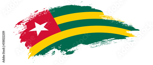 National flag of Togo with curve stain brush stroke effect on white background