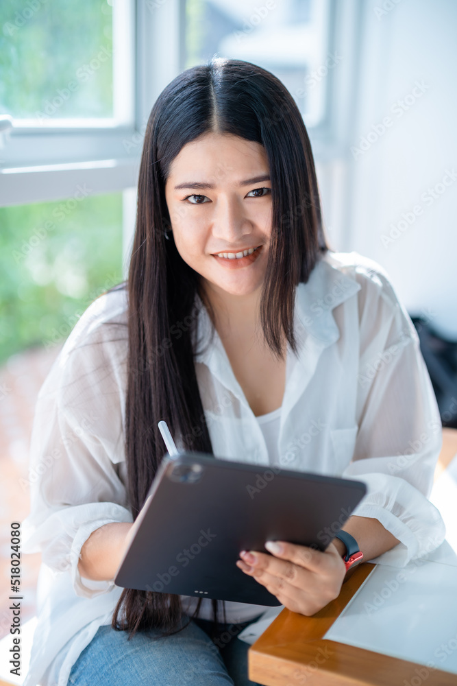 asian freelance people business female wearing smartwatch talking making using casual working with tablet for browsing internet, chatting and blogging and smartphone,notebook in coffee shop. asian freelance people business female wearing smartwatch talking making using casual working with tablet for browsing internet, chatting and blogging and smartphone,notebook in coffee shop.