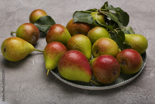 Ripe juicy pears on light cement  table, top view