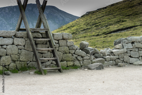 Rural Ireland wooden ladder over stone wall in the mountains