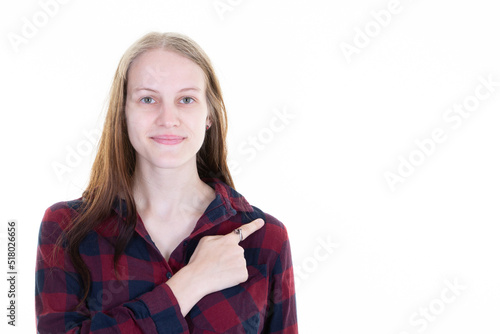 Portrait woman casual wear pointing fingers aside isolated over white background