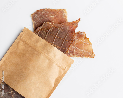 Natural dried treats for dogs. Treats for rewarding and training dogs. Dried meat products for dogs. Animal care.Selective focus. Advertisement for dog treats.