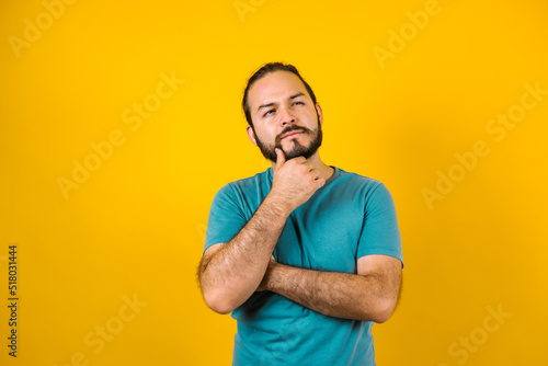 portrait of young hispanic man with copy space and thumbs up on yellow background in Mexico Latin America 