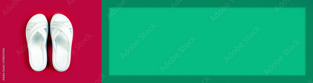 Women's summer white slippers on a red background. Slippers. Banner for insertion into site. Place for text cope space. Horizontal image Women's summer white slippers on a red background. Slippers. Banner for insertion into site. Place for text cope space. Horizontal image