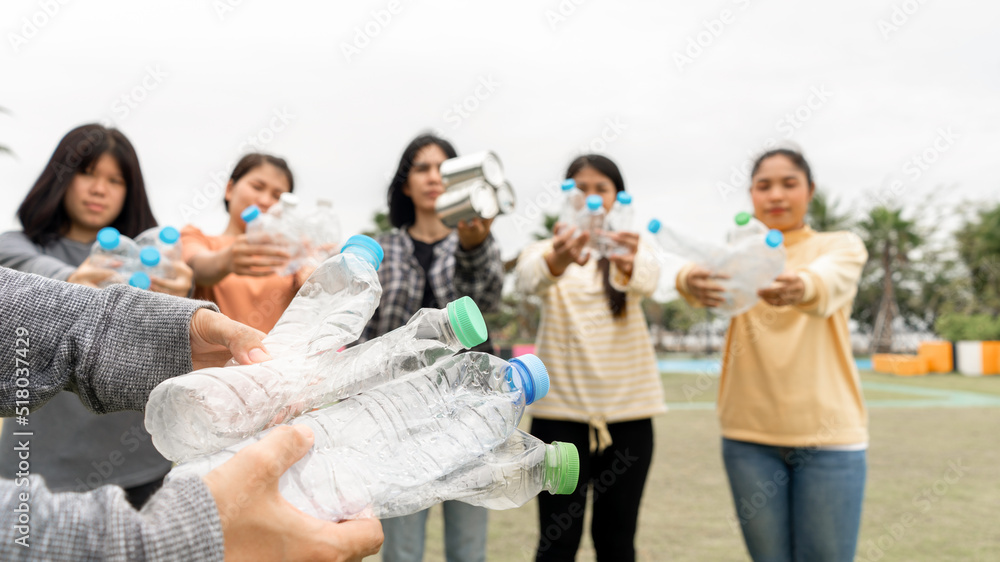 Woman Group Team Volunteer hand holding bottles garbage plastic Trash join empathy charity trust partner friendship. Volunteer team join hand at circle with bottles plastic Garbage waste at Park Woman Group Team Volunteer hand holding bottles garbage plastic Trash join empathy charity trust partner friendship. Volunteer team join hand at circle with bottles plastic Garbage waste at Park