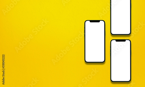 blank smartphones mockup over a yellow textured background