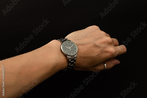 A girl tries on a hand watch in silver