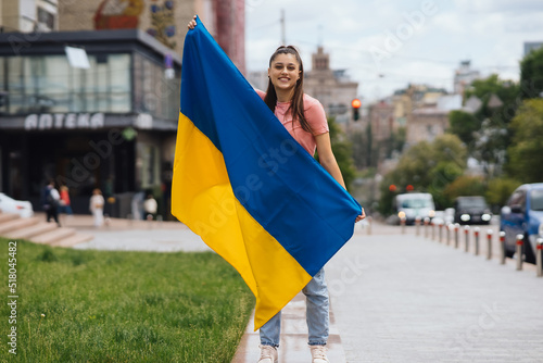 Young woman with national flag of Ukraine on the street