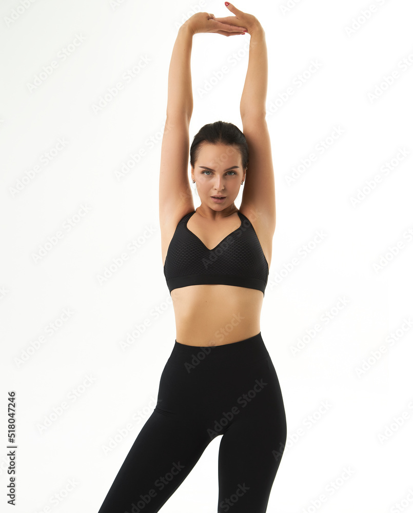 Perfect slim tanned young female body in sportswear. Concept perfect body, no fat, motivation, healthy lifestyle, fitness routine. Isolated white background. Perfect slim tanned young female body in sportswear. Concept perfect body, no fat, motivation, healthy lifestyle, fitness routine. Isolated white background.