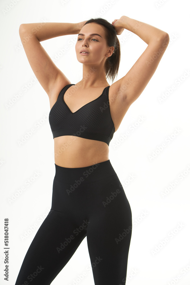 Perfect slim tanned young female body in sportswear. Concept perfect body, no fat, motivation, healthy lifestyle, fitness routine. Isolated white background. Perfect slim tanned young female body in sportswear. Concept perfect body, no fat, motivation, healthy lifestyle, fitness routine. Isolated white background.